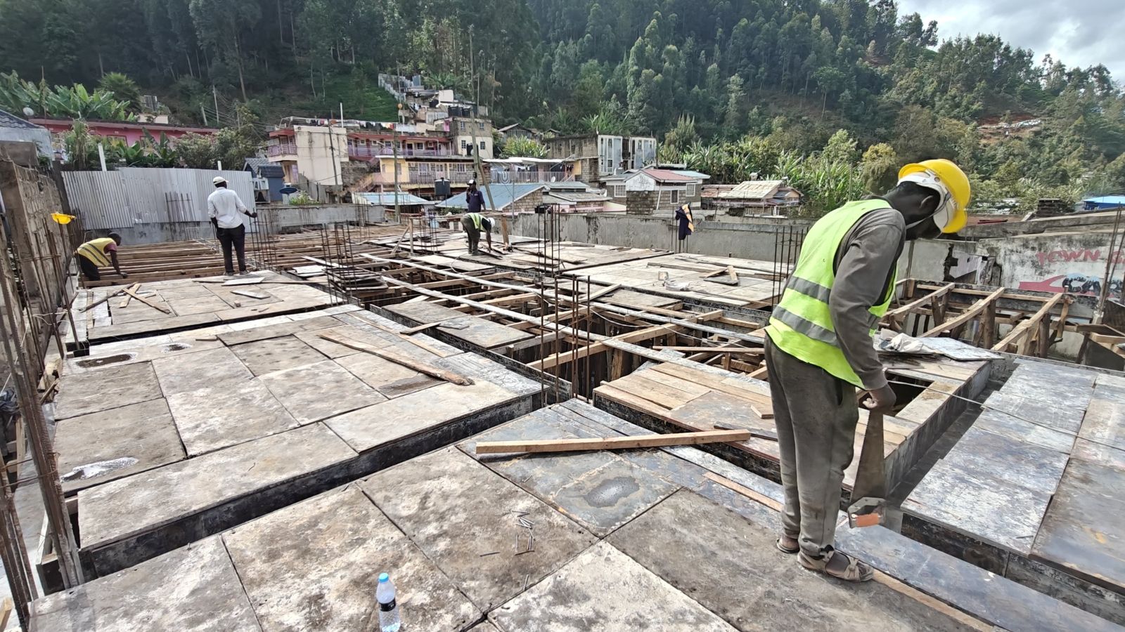 Slab formwork being prepared on site with workers in safety vests
